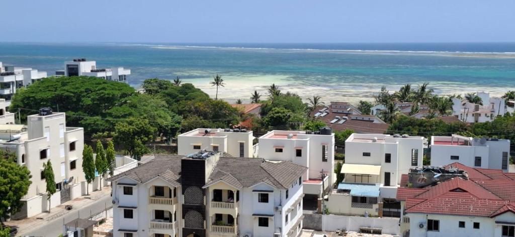 an aerial view of a city with houses and the ocean at Zamia Heights Apartments in Gatunga