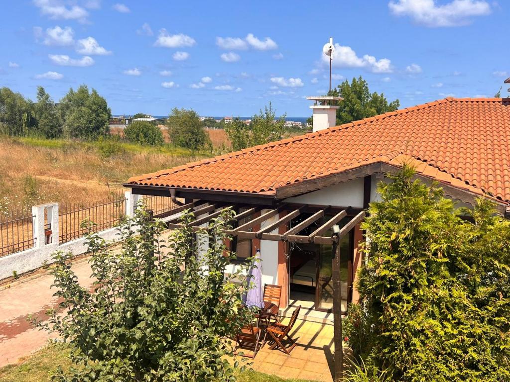 a house with a red roof and some bushes at Velika Garden Villas 1 bedroom apartment, Lozenets in Lozenets