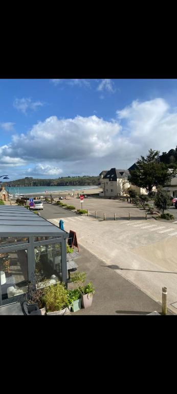 a view of a parking lot and a beach at Duplex plage de brehec in Plouézec