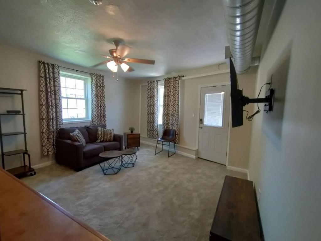 a living room with a couch and a ceiling fan at Neville Island Motel in Pittsburgh