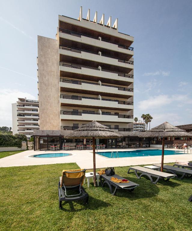 a resort with a pool and a large building at Interpass Vau Hotel Apartamentos in Portimão