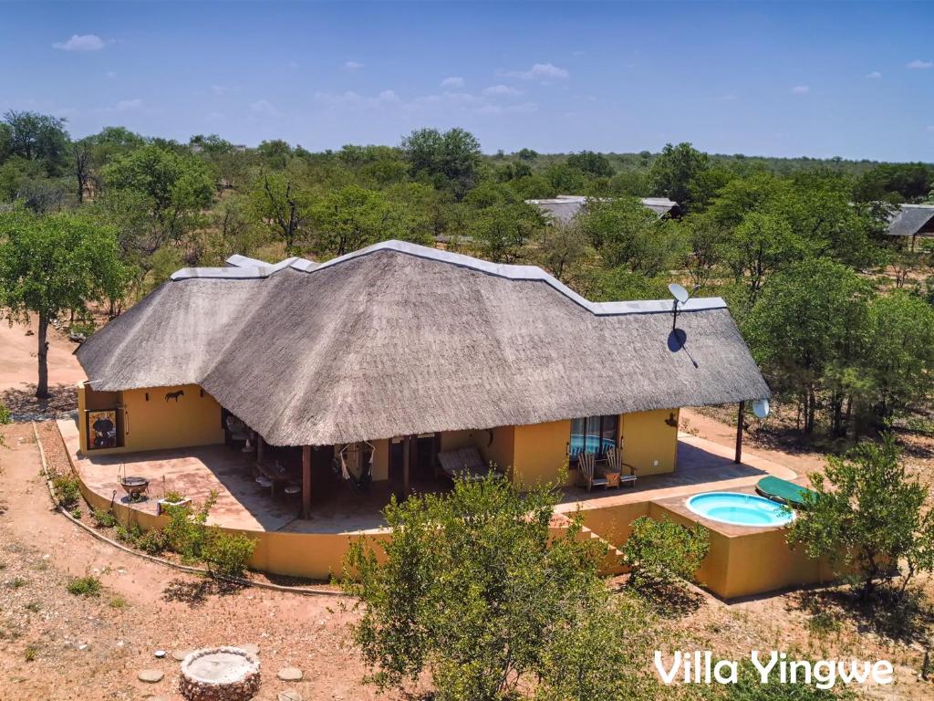 an aerial view of a house with a thatched roof at Luxury Self Catering Villas at Krugers Edge with Jacuzzi in Phalaborwa