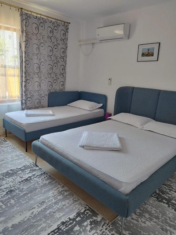 a room with two beds and a couch at Casa Ancora Sulina in Sulina
