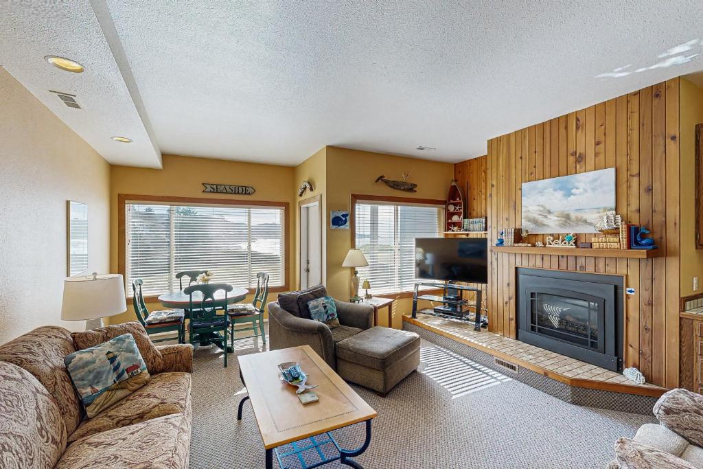 a living room with a couch and a fireplace at A Whale's Walk - Mariner 2 in Depoe Bay