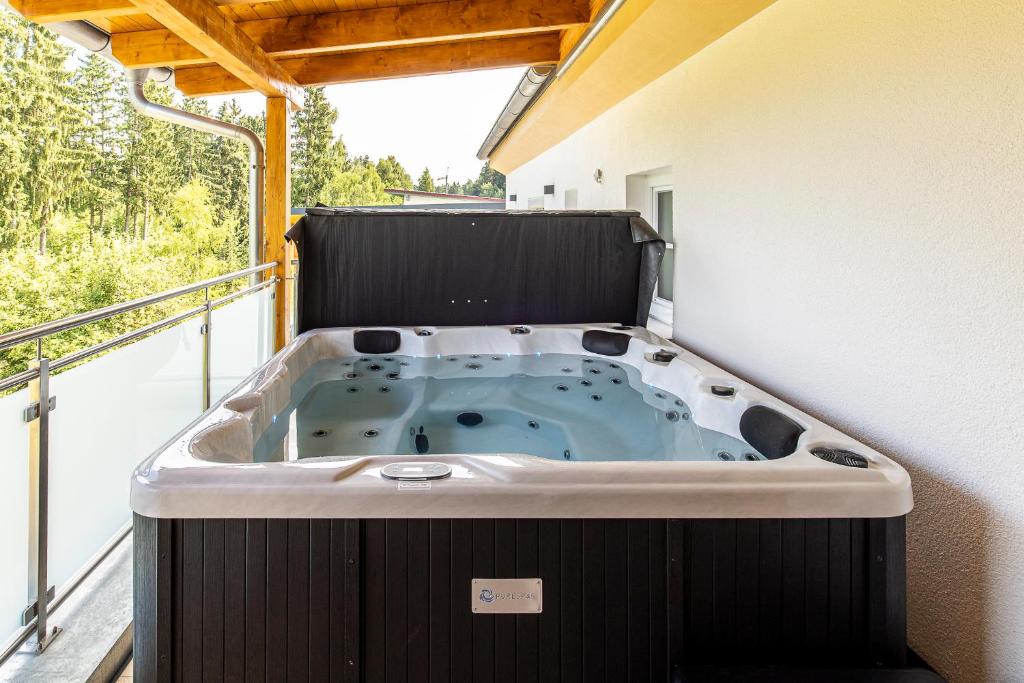 a jacuzzi tub in the corner of a house at Ferienbahnhof Fichtental Gleisblick Lounge in Prackenbach