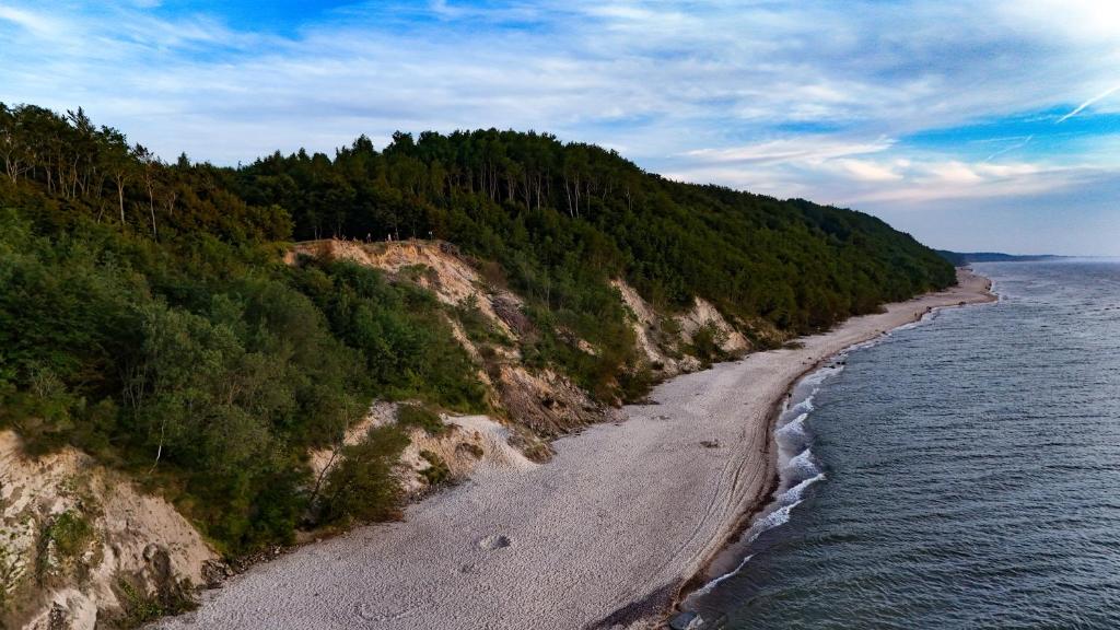 an aerial view of a beach next to the water at Amber House Swierkowa in Debina