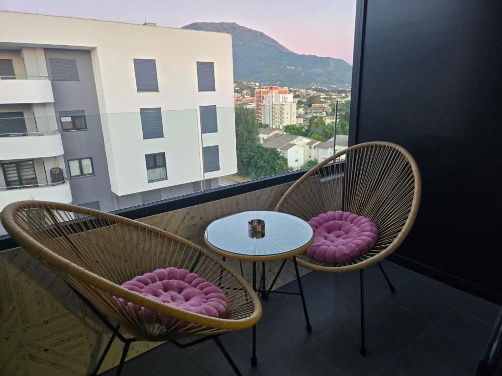 two chairs and a table on a balcony with a view at Apartment Lule in Bar