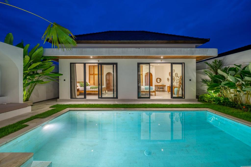 a villa with a swimming pool in front of a house at Ferreno Villa - Family-Friendly Designer Villa- Private Pool - Central in Kerobokan
