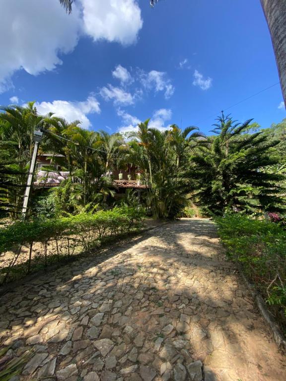 a road leading to a resort with palm trees at Casa em Guaramiranga, ao meio da Natureza! in Guaramiranga