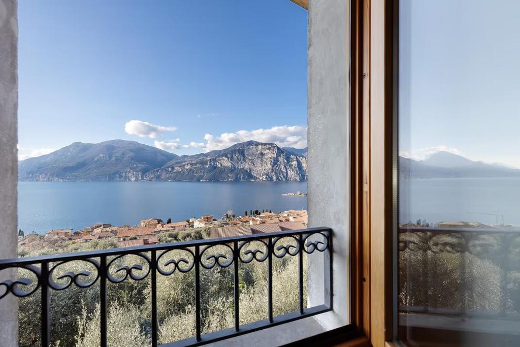 a view of a lake from a window at Intera casa Lago di Garda in Brenzone sul Garda