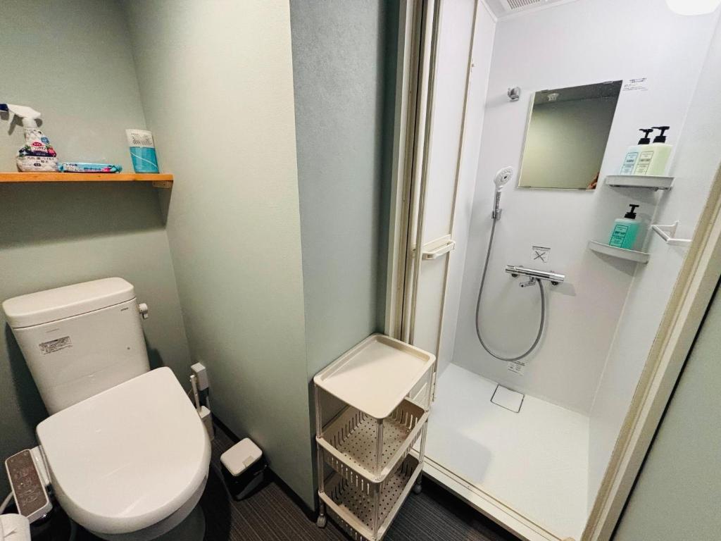 a small bathroom with a toilet and a shower at Wasabi Mita Hotel - Vacation STAY 84702v in Tokyo