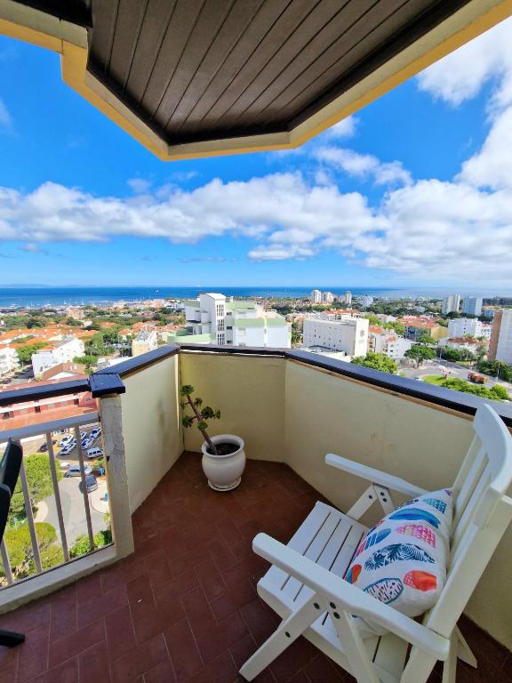 a balcony with two chairs and a view of the city at Sea view Cascais in Cascais