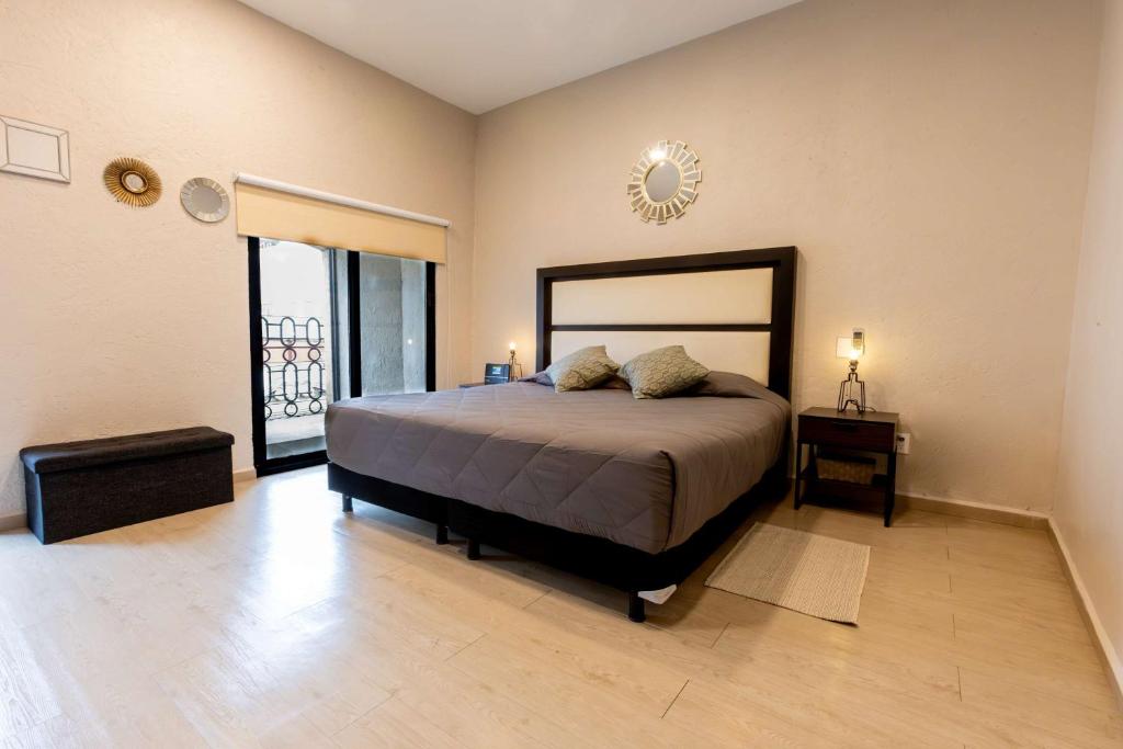 a bedroom with a large bed and a balcony at 304 Balcony apt Walk to Zocalo AC Rooftop in Mexico City