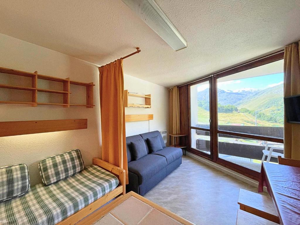 a living room with a couch and a large window at Résidence Grande Masse - Studio de 19m² pour 3 personnes avec balcon exposé Sud MAE-5774 in Les Menuires