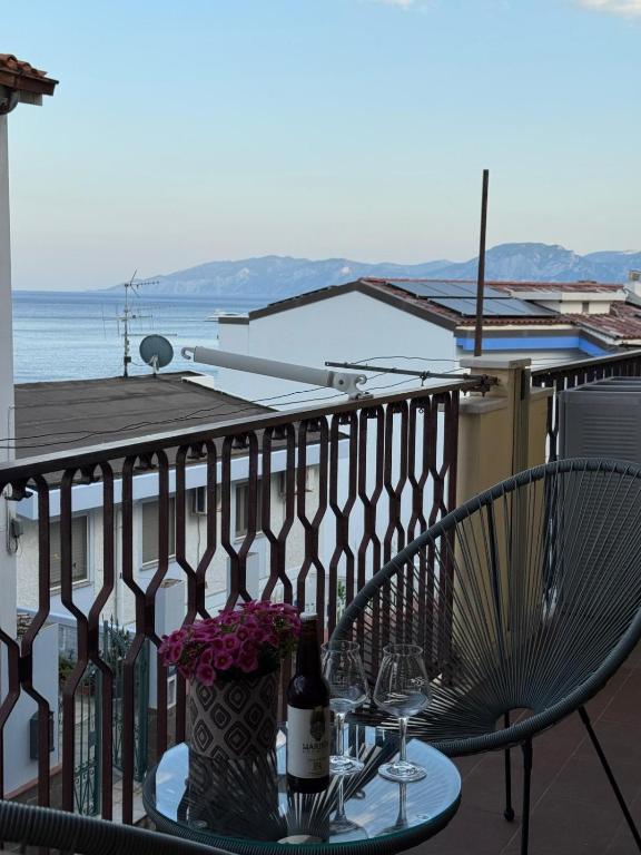 a table with a bottle of wine on a balcony at VistaMare21 in Cala Gonone
