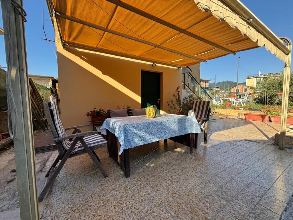 a table and chairs on a patio under awning at La casa della rondine in Rapallo