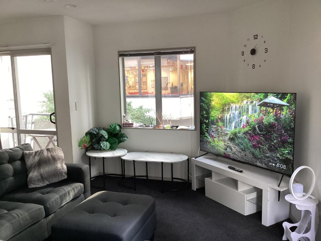 Una sala de estar con un televisor de pantalla plana grande. en 6 Scotia, en Auckland