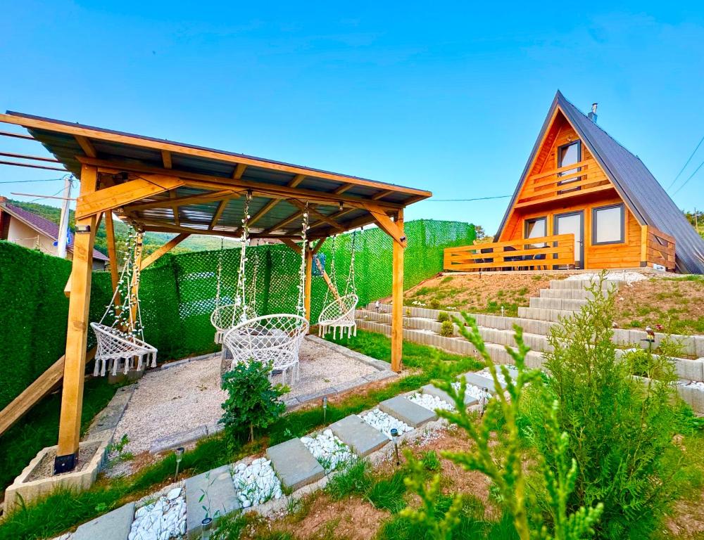 a backyard with a swing and a house at Villa Roi 3 in Ferizaj
