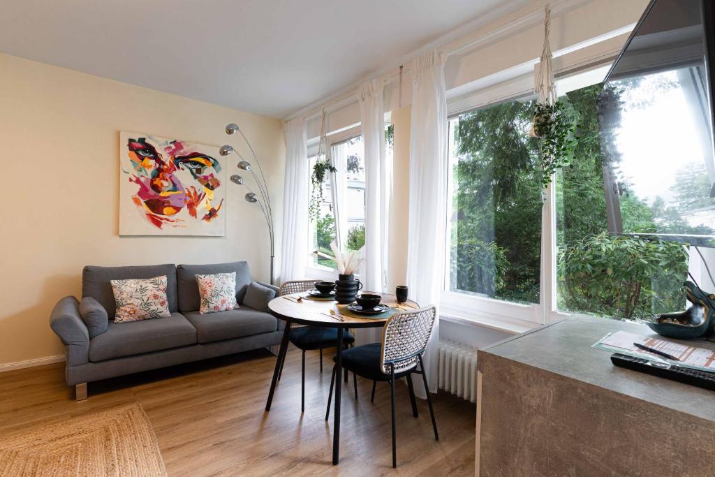 a living room with a couch and a table at LITZI Apartment in Baden-Baden