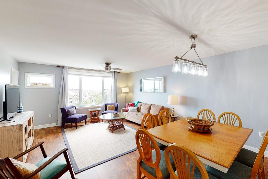 a living room with a table and a couch at Turn of River 4F in Folly Beach