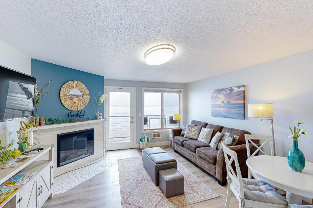 a living room with a couch and a table at On The Sand in Rockaway Beach