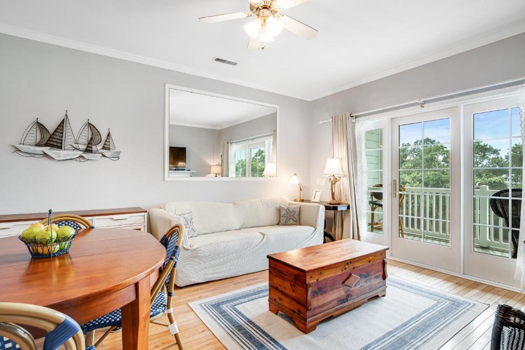 a living room with a couch and a table at Marsh Winds 2K in Folly Beach