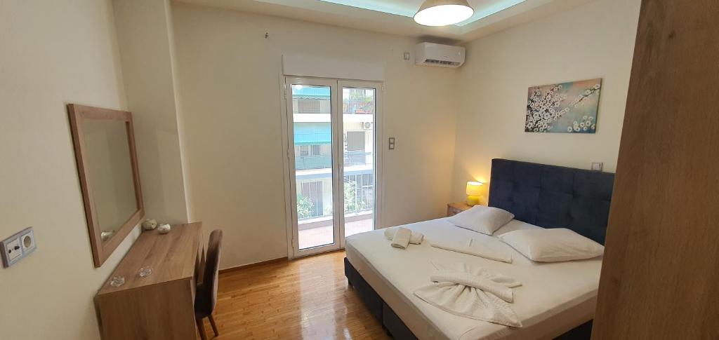 a small bedroom with a bed and a window at A few minutes from Siggrou Street in Athens