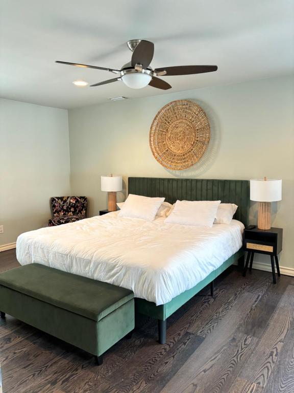 a bedroom with a large bed with a ceiling fan at Best location in McAllen pool perfect for groups in McAllen