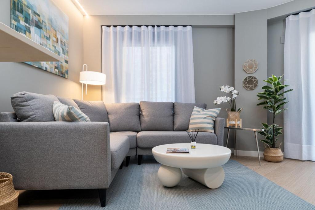 a living room with a couch and a coffee table at Apartamentos Torre del Reloj in Jaca