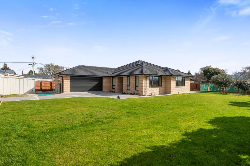 a house with a large lawn in front of it at The Settlers Stay - Reporoa Holiday Home in Waiotapu