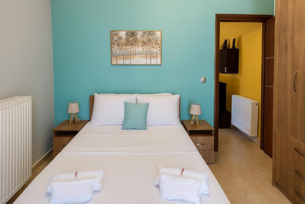 a bedroom with a large white bed with two pillows at Harmony apartment near Dassia, Ipsos in Ipsos