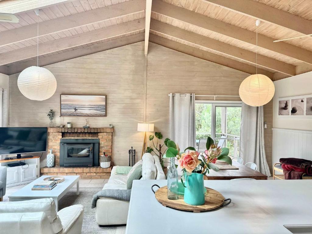 a living room with white furniture and a fireplace at The Vibe Sandy Point Stay 3 Pay 2 Winter Special in Sandy Point