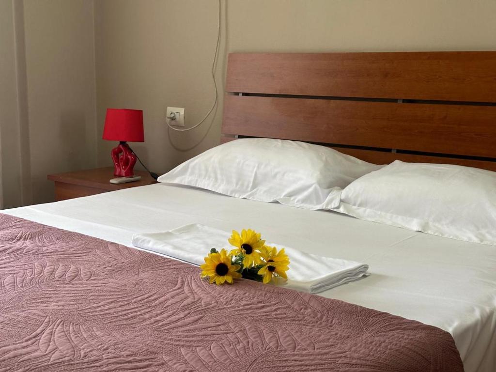 a bed with two yellow flowers on top of it at Turdiu center apart in Tirana