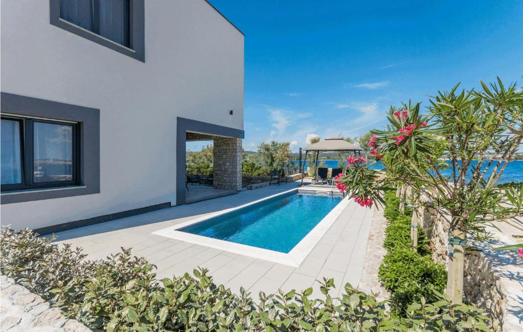 a swimming pool in the backyard of a house at Villa Royal House 1 in Pašman