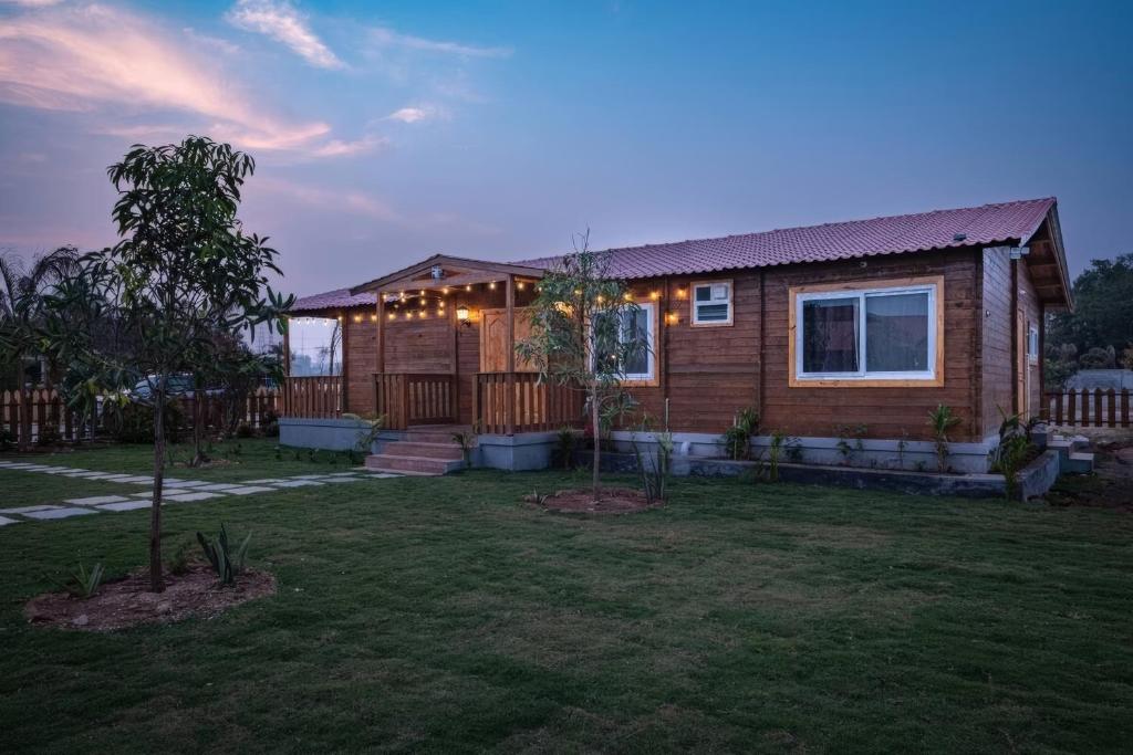 a home with a yard with a house at Rustic Wood - The Cozy Nature Escape in Venkatāpur