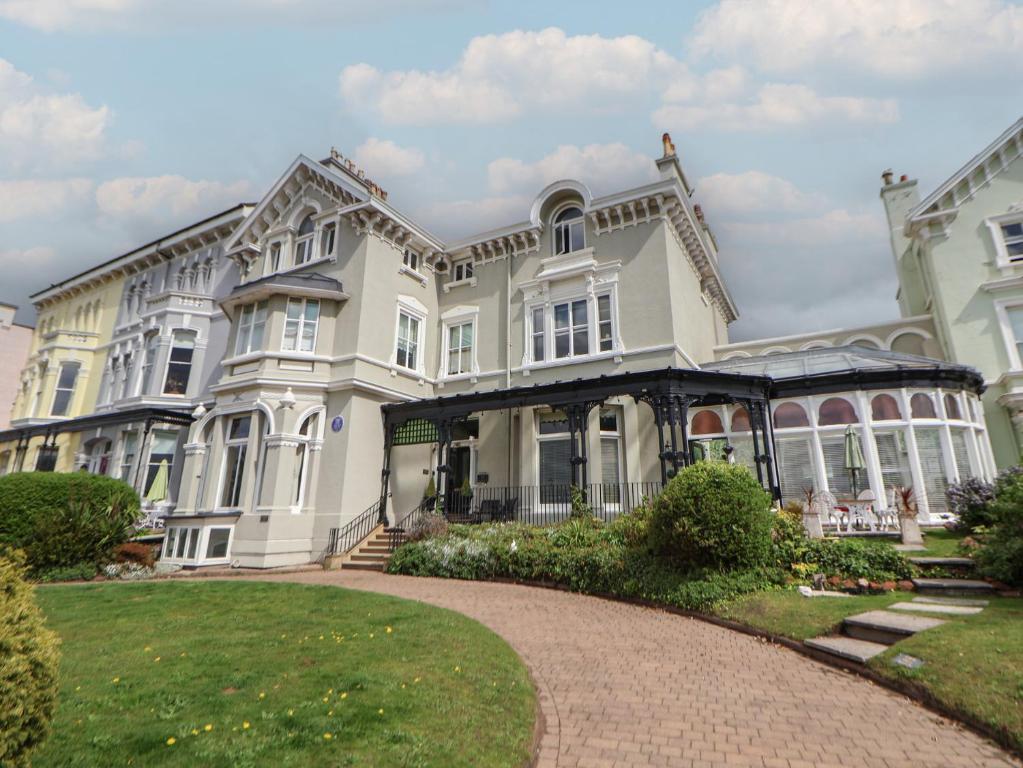 a large white house with a pathway in front of it at Ismay Billiard Room Apartment - Titanic Interest in Crosby