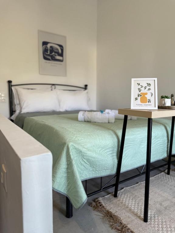 a bedroom with a bed with a night stand next to it at Bloom Yard in Triovasálos