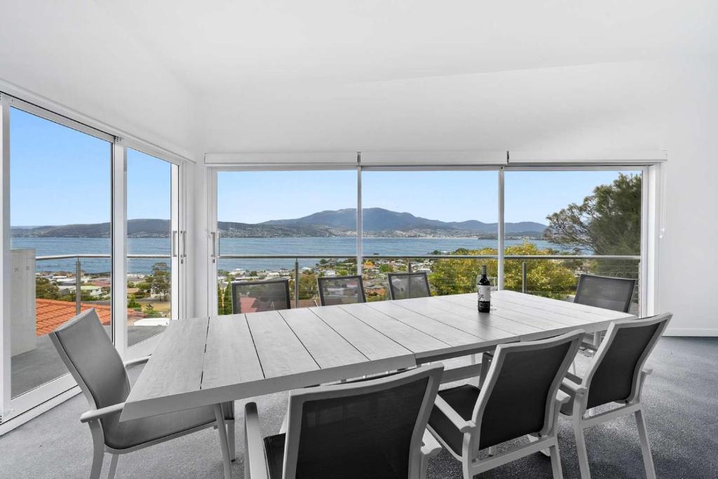 a dining room with a large table and chairs at Hillside Hideaway Sleeps 10 Stunning Views in Howrah