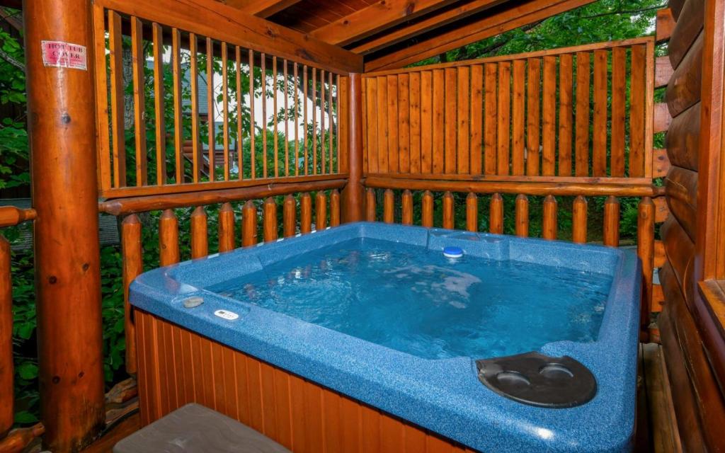 a jacuzzi tub in a wooden house at Rockin in the Smokies in Pigeon Forge