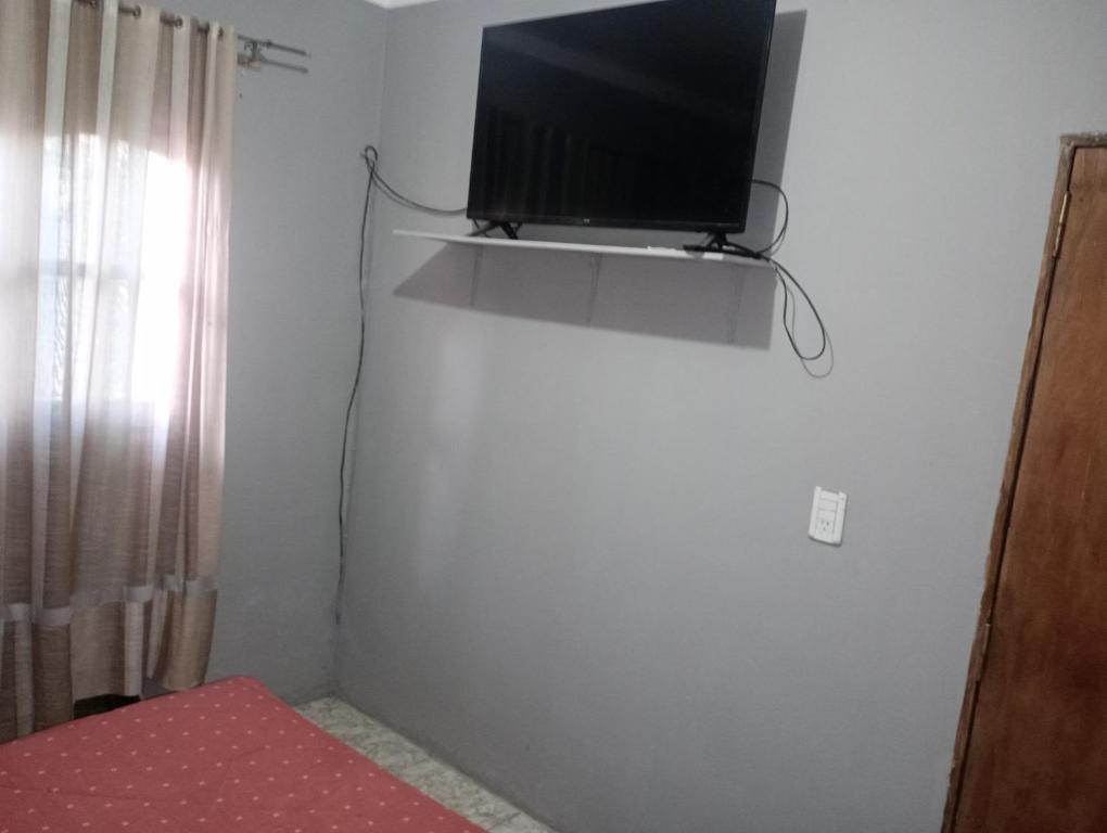 a flat screen tv on a wall in a room at Casa Marcelo in Salta