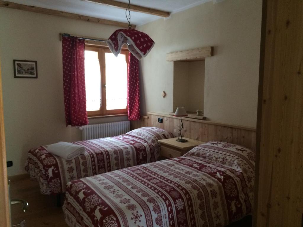Postel nebo postele na pokoji v ubytování Le Petit Fenestrelle
