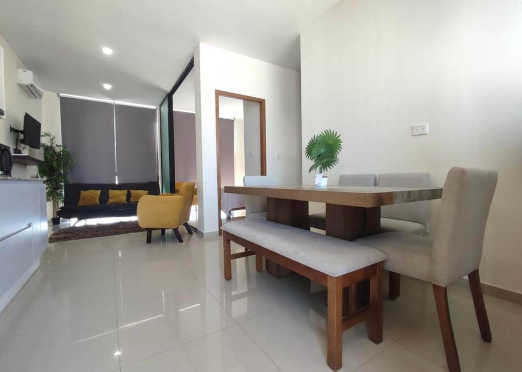 a living room with a dining room table and chairs at Departamento en Mazatlán in Mazatlán