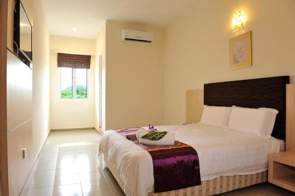 Postel nebo postele na pokoji v ubytování OYO 90835 Geopark Hotel Kuah