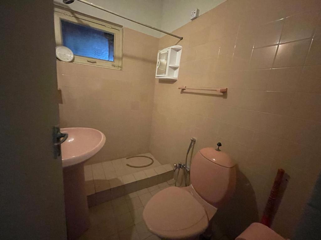 a bathroom with a toilet and a sink at Ayyan Cottage G 10-2 in Islamabad