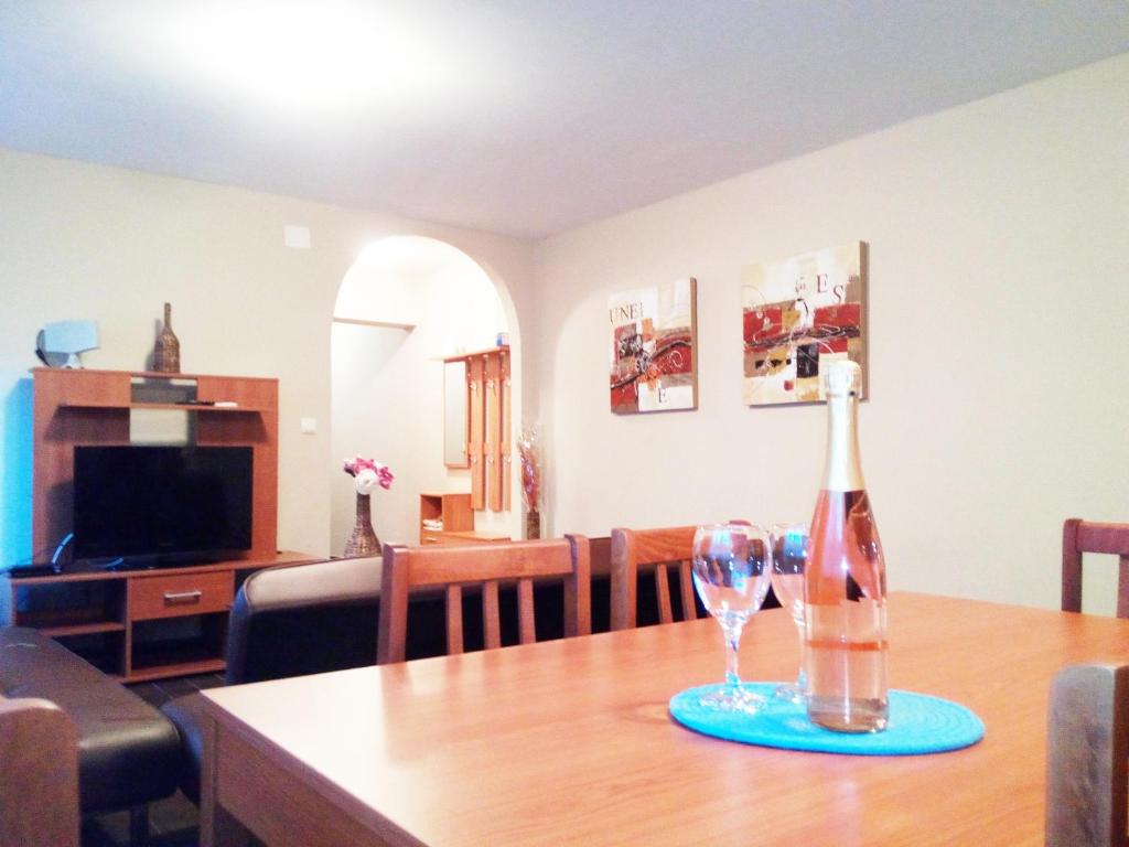 a bottle of wine and two glasses on a table at Holiday Home Turalija in Vodice