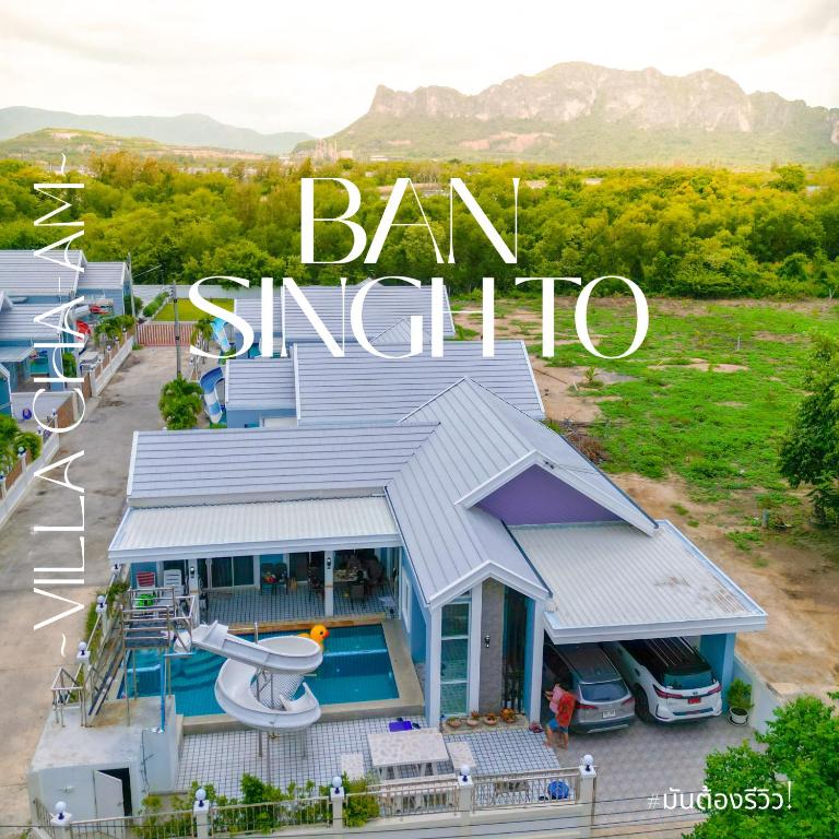 a house with a swimming pool and the words ban singapore at BAN SINGH TO Poolvilla in Cha Am