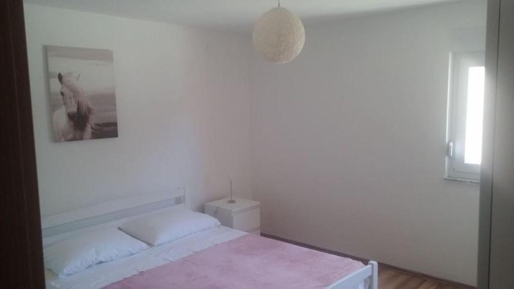 Postel nebo postele na pokoji v ubytování Apartments Andelic