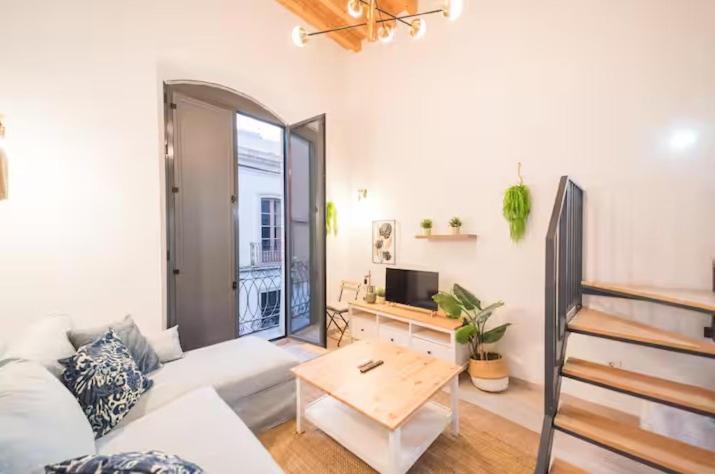 a living room with a couch and a table at Apartamentos San Francisco con Terraza privada by Expoholidays in Almería