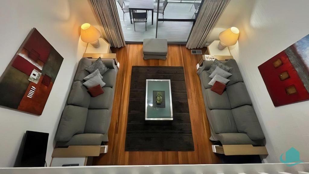 an overhead view of a living room with two couches at Plover Executive Deluxe Villa 25 in Cams Wharf