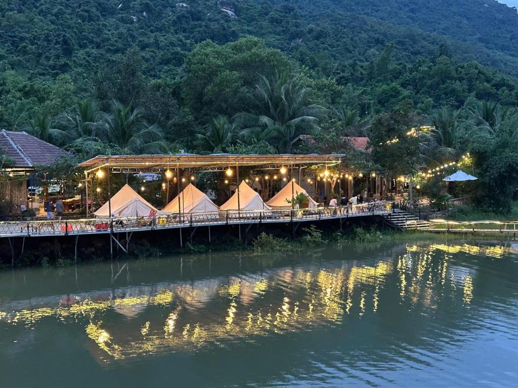 a restaurant on a bridge over a river at Z Camp Nha Trang in Nha Trang